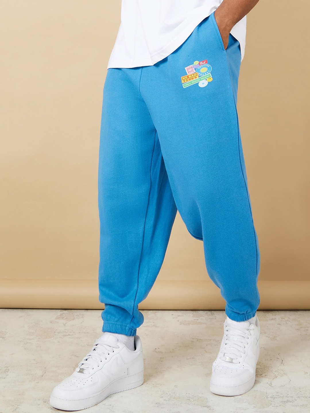 

Styli Men Graphic Printed Relaxed Fit Pure Cotton Joggers, Blue
