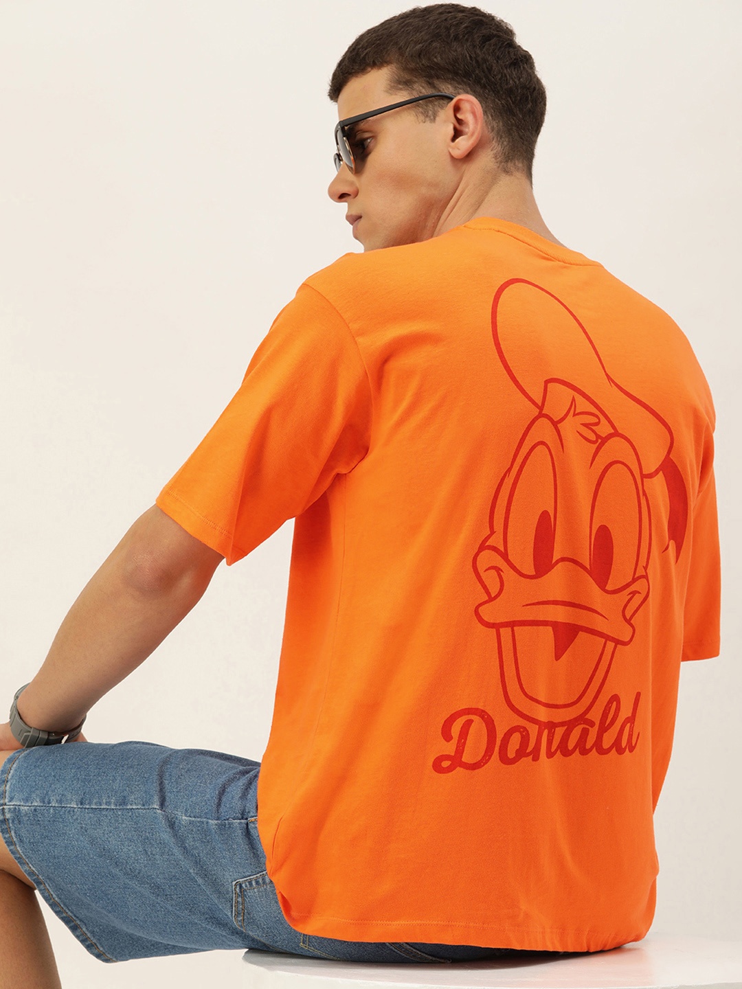 

Kook N Keech Donald Duck Printed Drop-Shoulder Sleeves Oversized Pure Cotton T-shirt, Orange