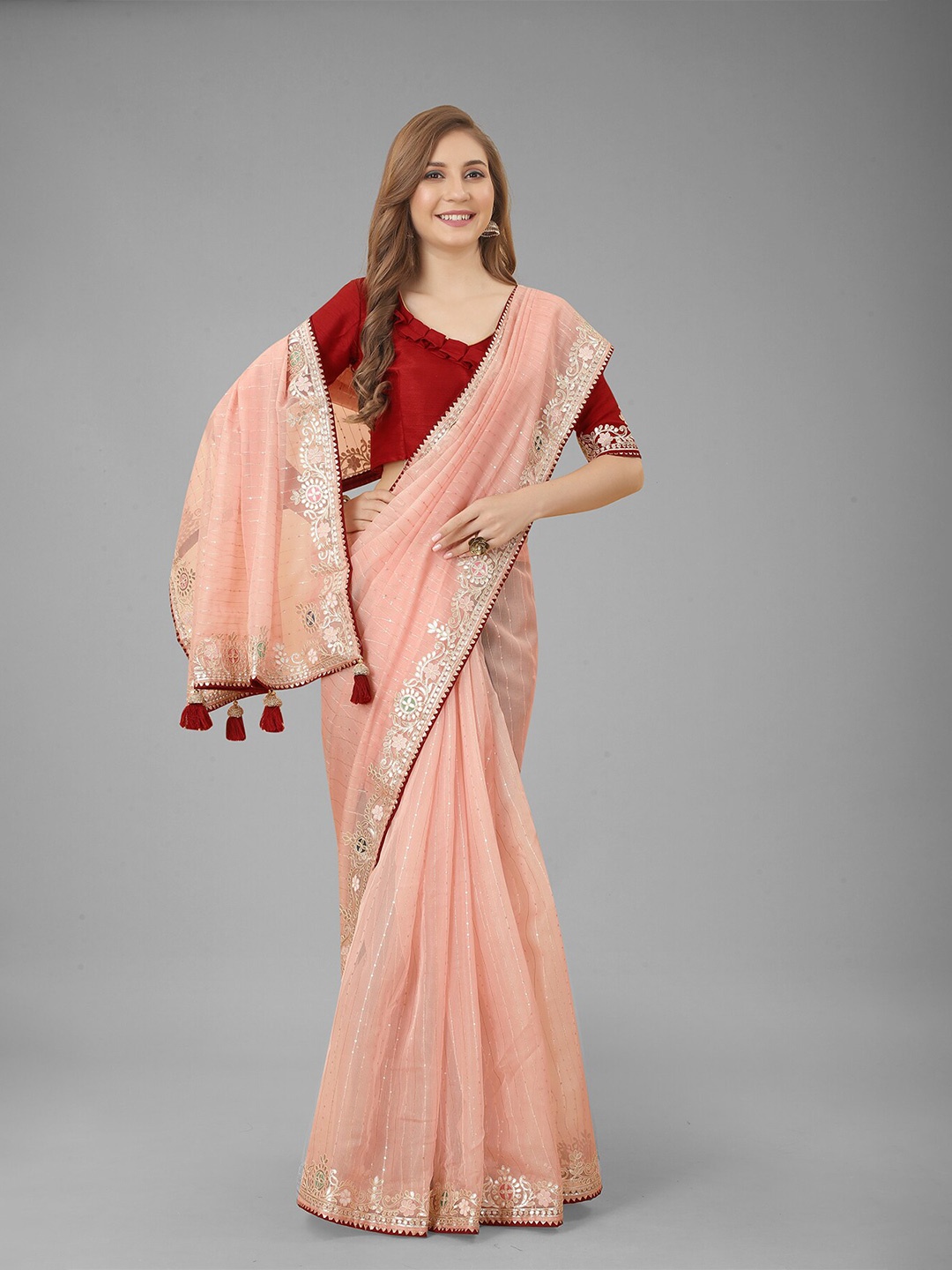 

N N ENTERPRISE Peach-Coloured & Gold-Toned Embellished Embroidered Net Saree