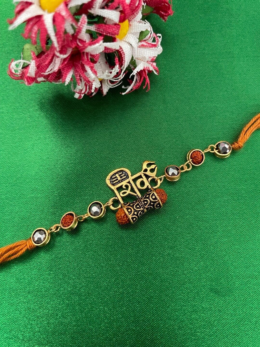 

Digital Dress Room Shiva With Damru & Rudraksha Charm Rakhi, Gold