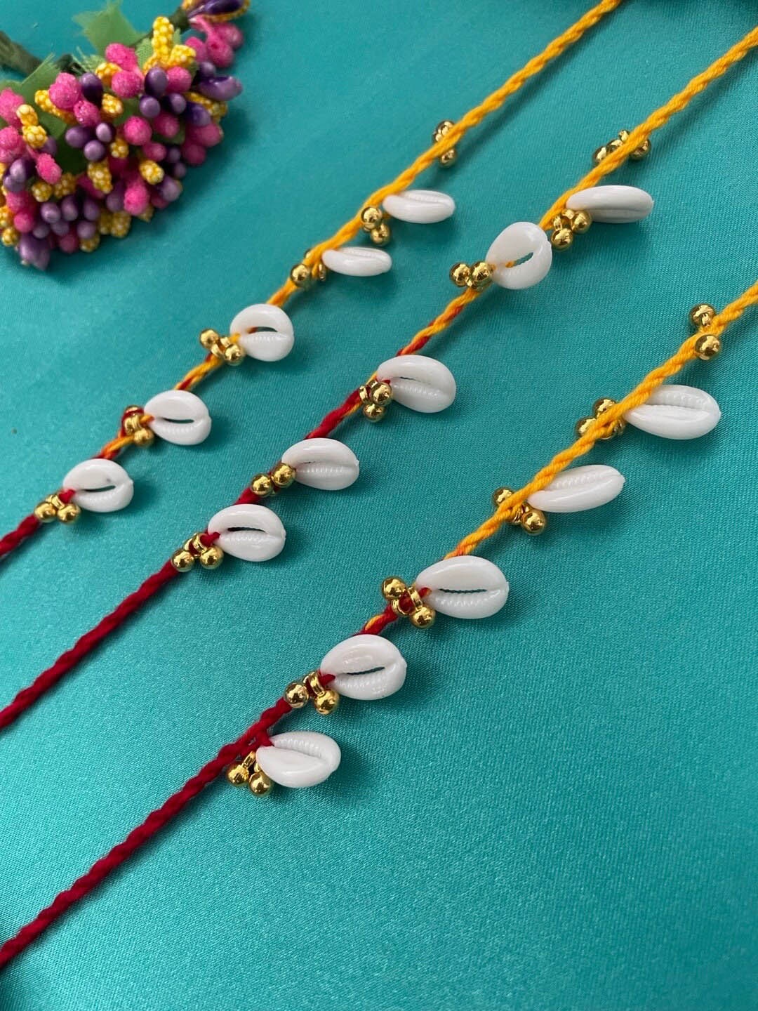 

Digital Dress Room Set Of 3 Sea-shell & Ghungroo Beaded Rakhis, White