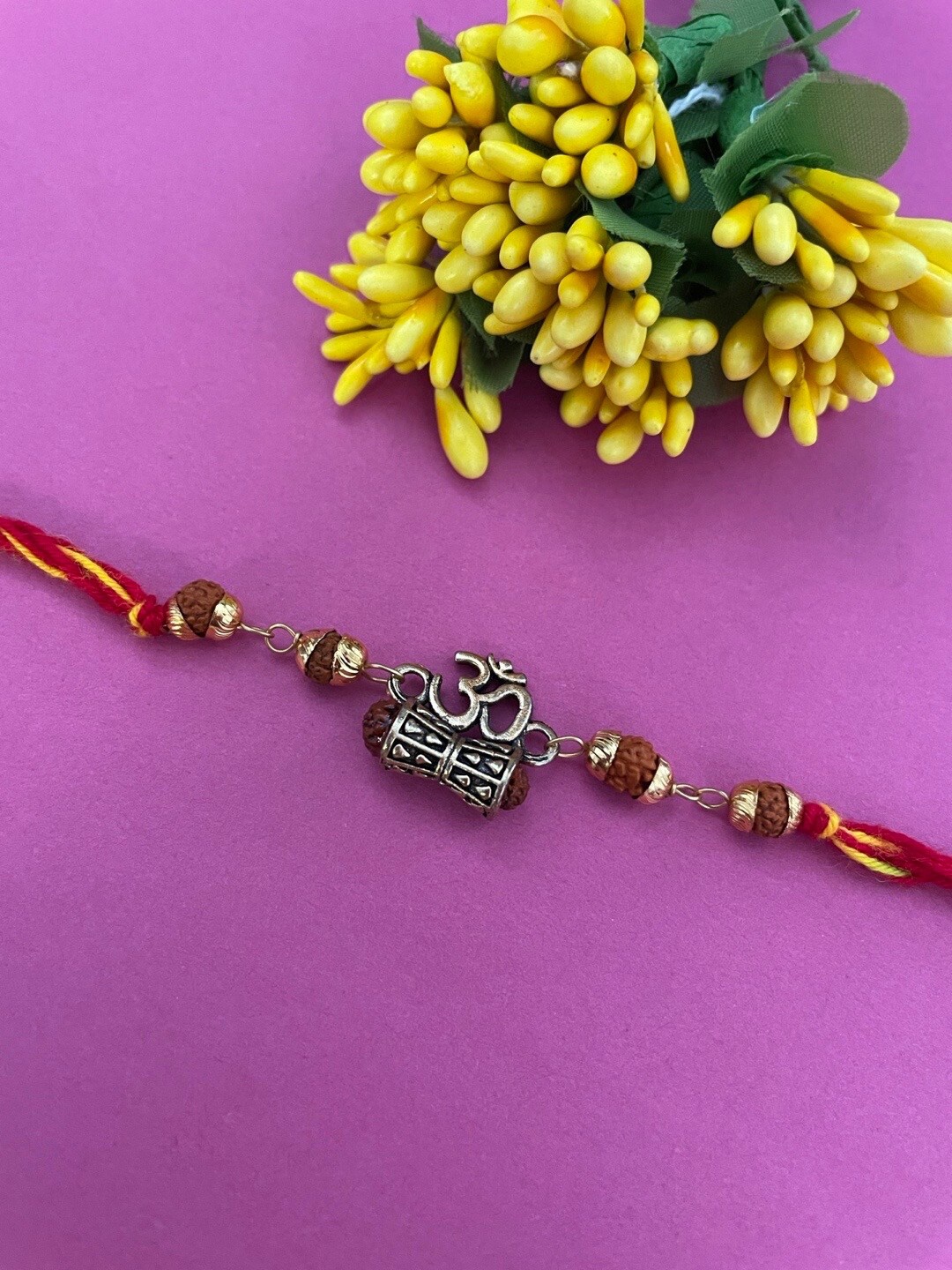 

Digital Dress Room Gold-Plated Om With Damru & Rudraksha Beaded Rakhi