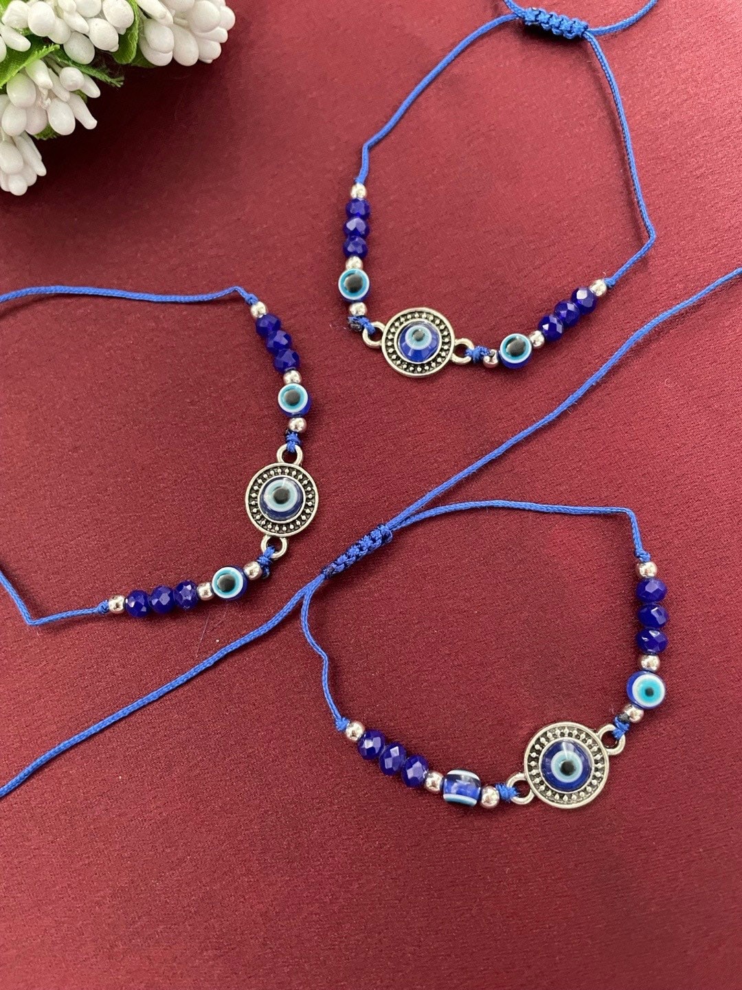 

Digital Dress Room Set Of 3 Evil Eye Beaded Thread Rakhis, Blue