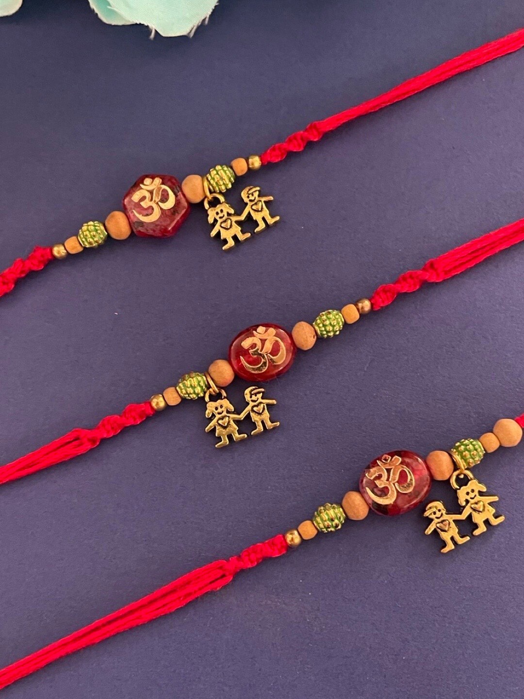 

Digital Dress Room Set Of 3 Om & Beaded Thread Rakhis, Gold