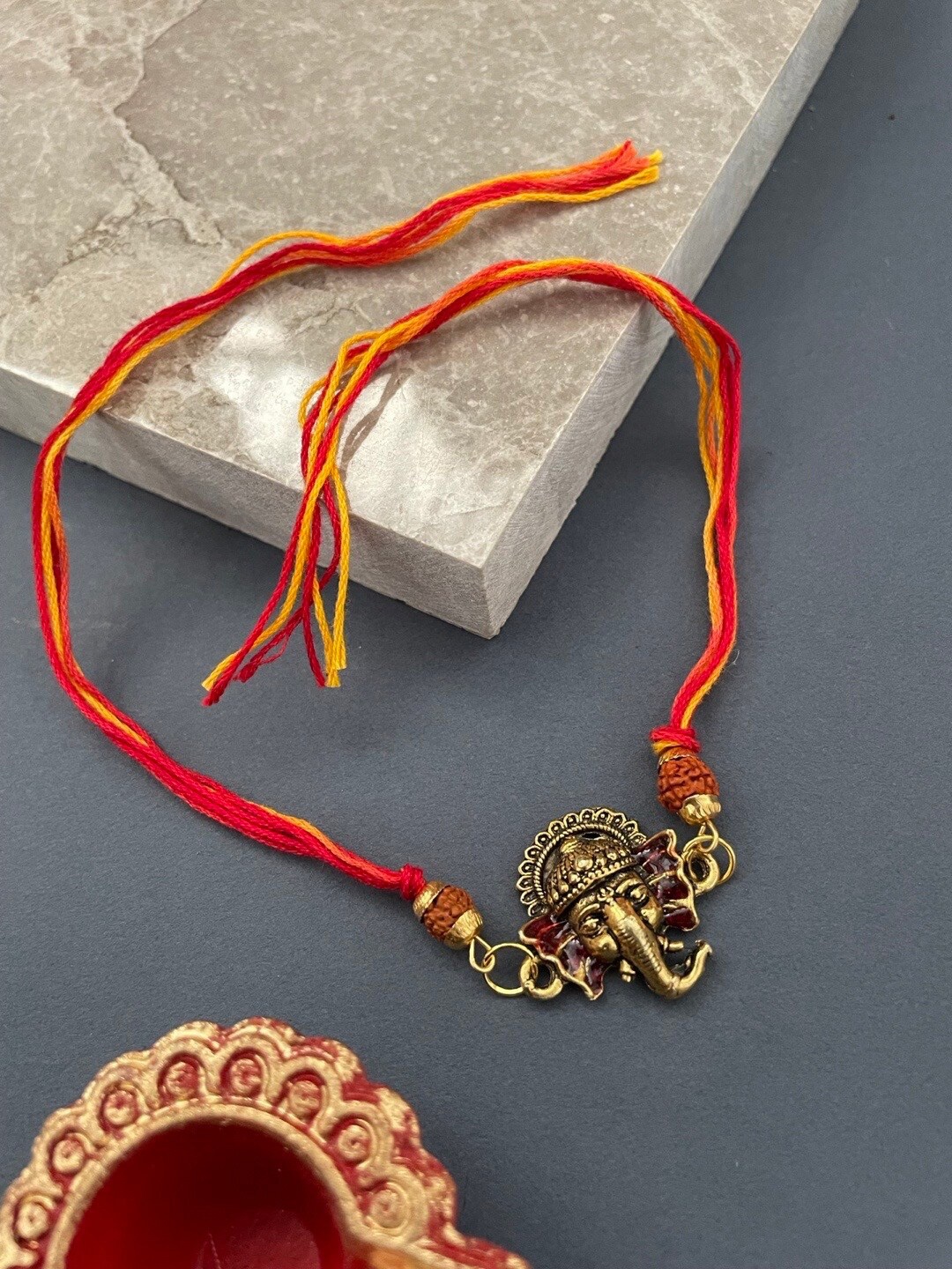 

Digital Dress Room Lord Ganesha & Rudraksha Thread Rakhi, Gold