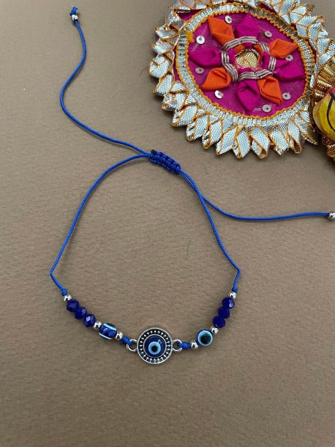 

Digital Dress Room Evil Eye Charm Beaded Thread Rakhi, Navy blue
