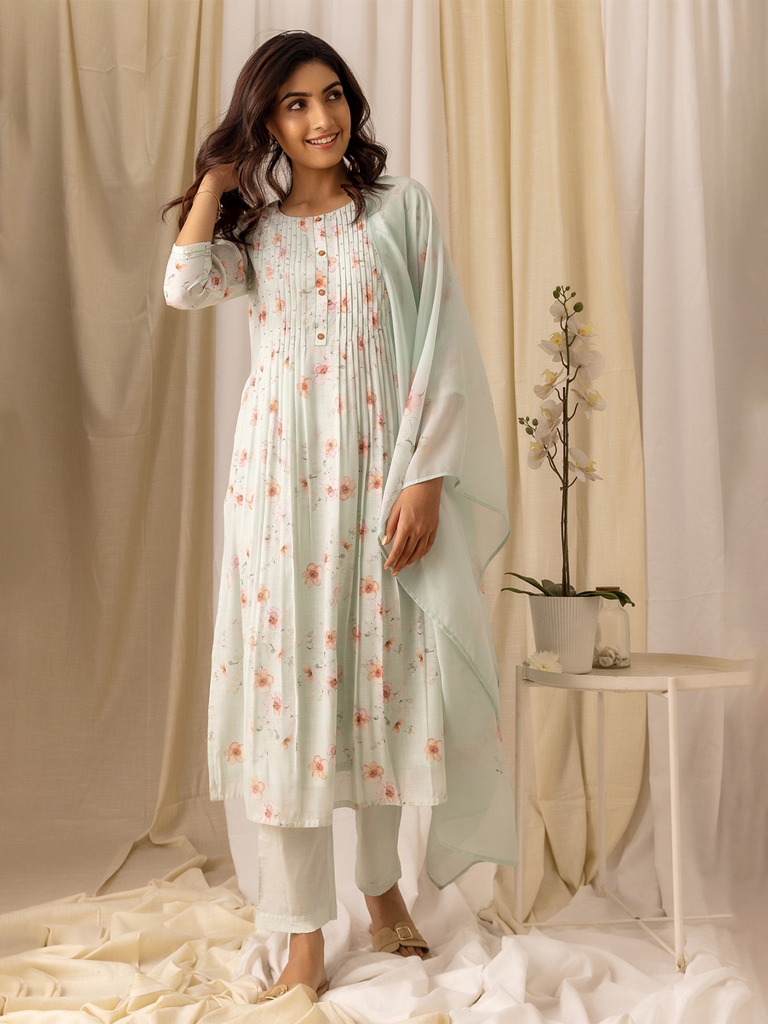 

Ishin Turquoise Blue Floral Printed Pleated Linen A-Line Kurta With Trousers & Dupatta