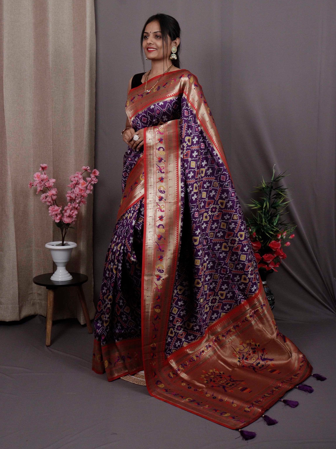 

Mitera Purple & Red Ethnic Motifs Woven Design Zari Patola Saree