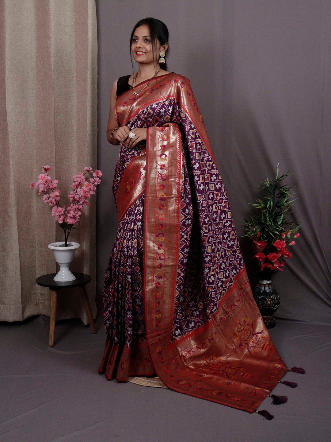 

Mitera Purple & Red Ethnic Motifs Woven Design Zari Patola Saree