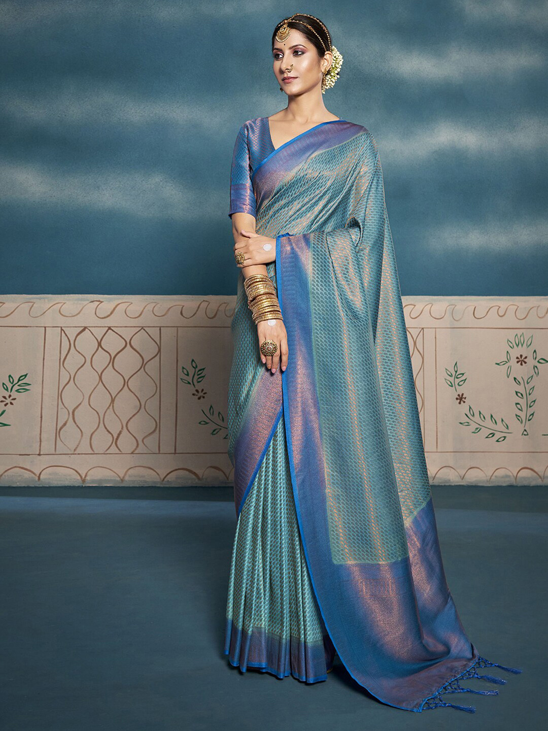 

Mitera Turquoise Blue & Gold-Toned Ethnic Motifs Woven Design Zari Saree