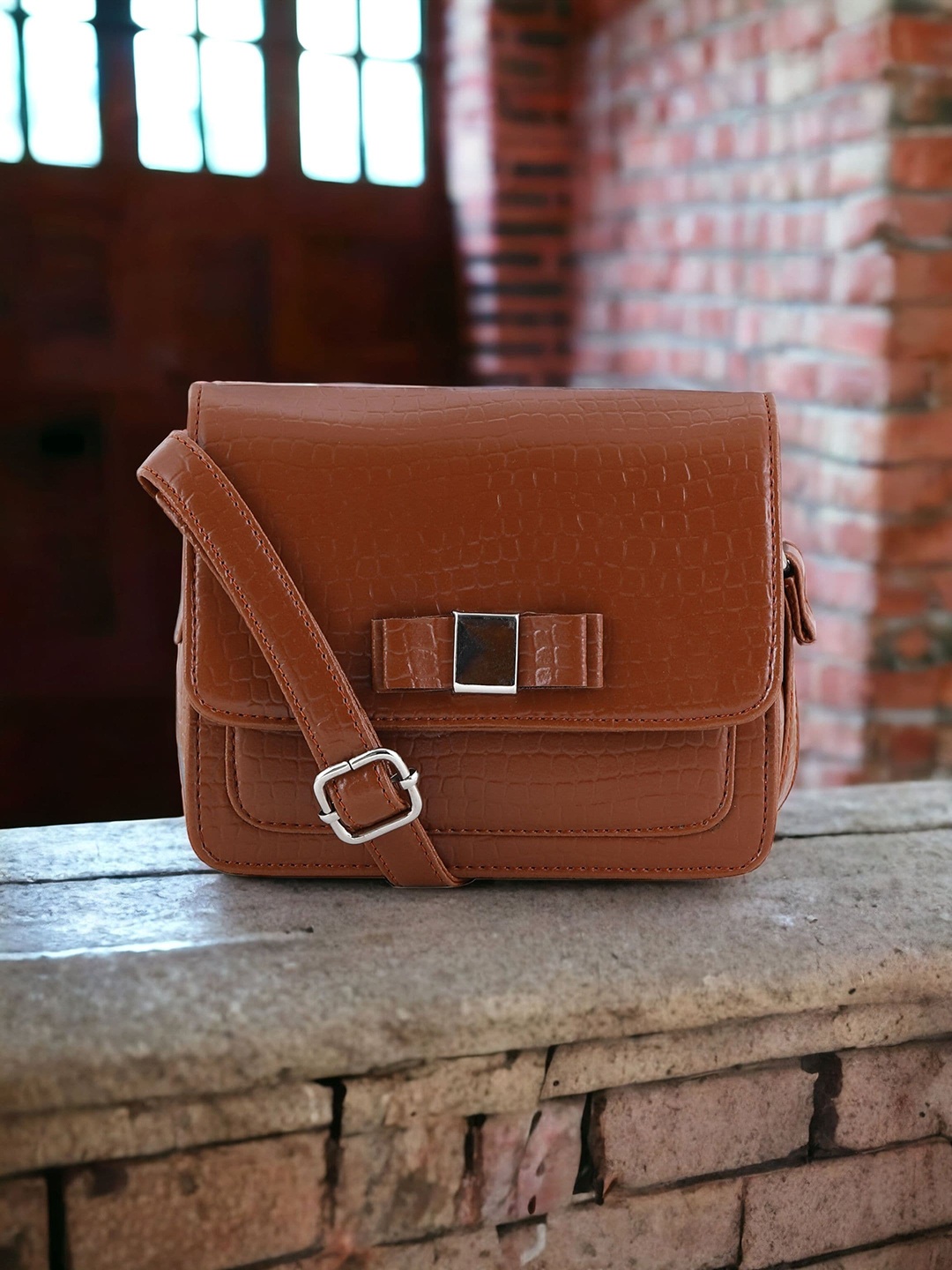 

Toteteca Tan Textured PU Structured Sling Bag With Bow Details