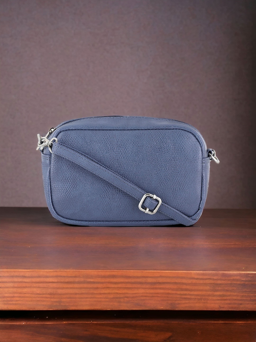 

Toteteca Textured Bowling Sling Bag, Blue