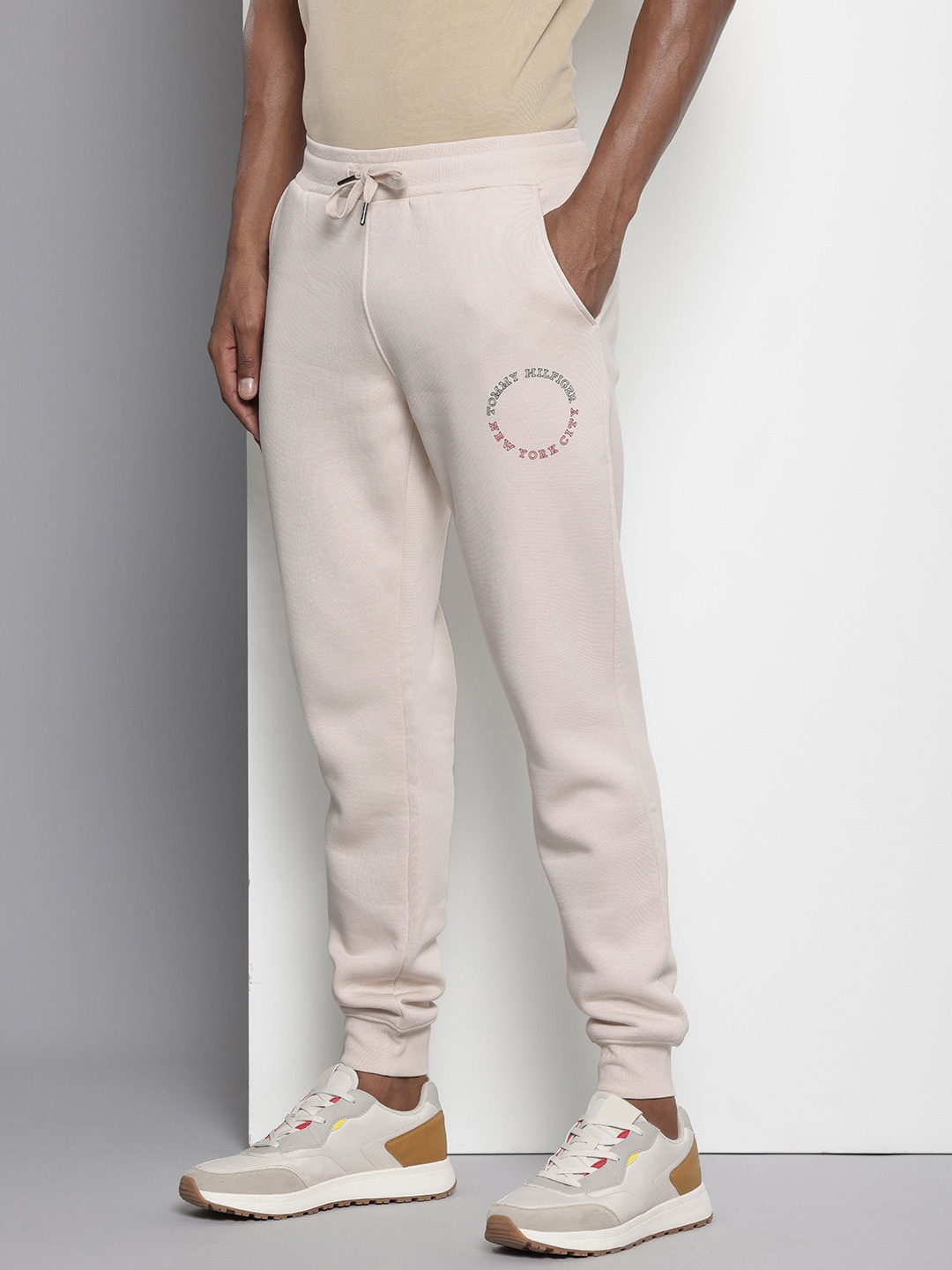 

Tommy Hilfiger Men Brand Logo Printed Joggers Track Pants, Beige