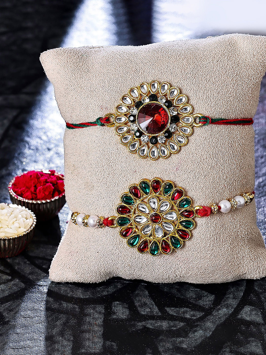 

Sukkhi Rakhi Set Of 2 Gold-Plated Floral Charm Rakhi With Roli, Rice & Greeting Card, Red