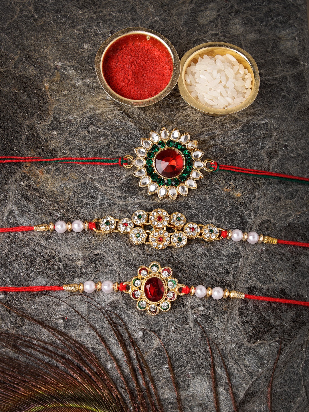 

Sukkhi Rakhi Set Of 3 Gold-Plated Stone-Studded Rakhi With Roli, Rice & GreetingCard