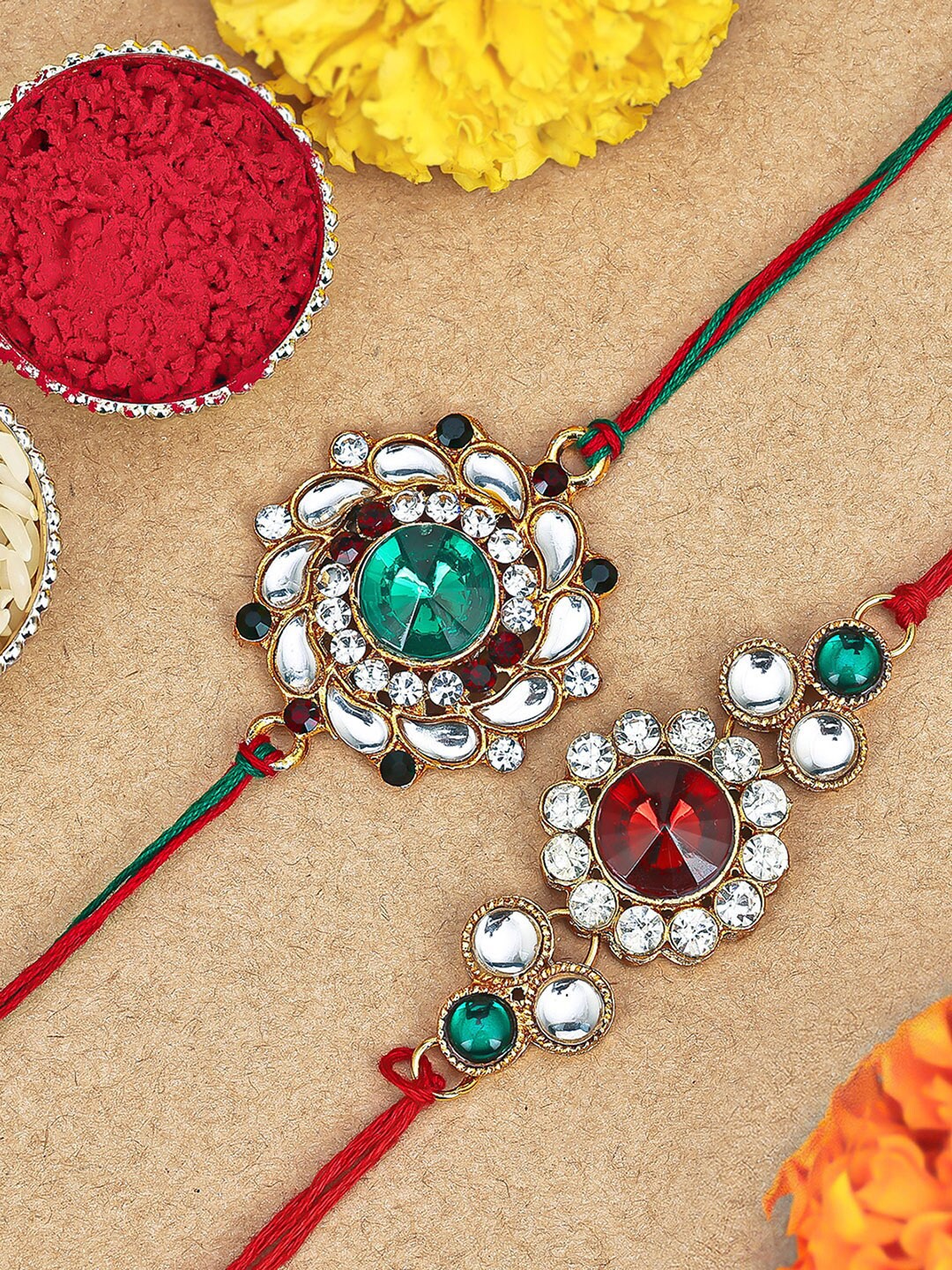 

Sukkhi Rakhi Set Of 2 Gold-Plated Stone-Studded Rakhi With Roli, Rice & Greeting Card, Red