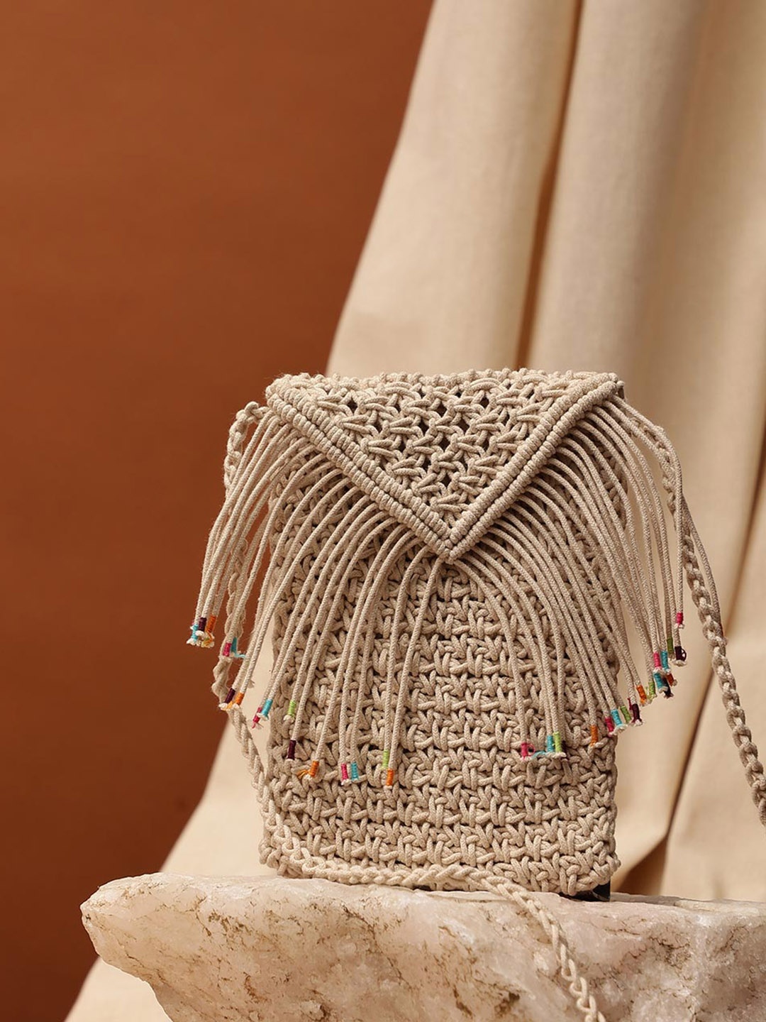 

Fabindia Geometric Structured Sling Bag with Tasselled, Off white