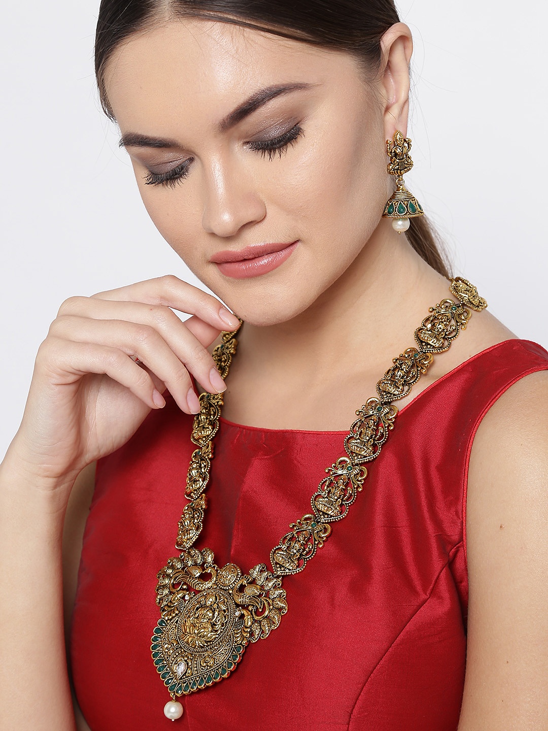 

Zaveri Pearls Antique Gold-Toned Goddess Lakshmi-Textured Stone-Studded Jewellery Set