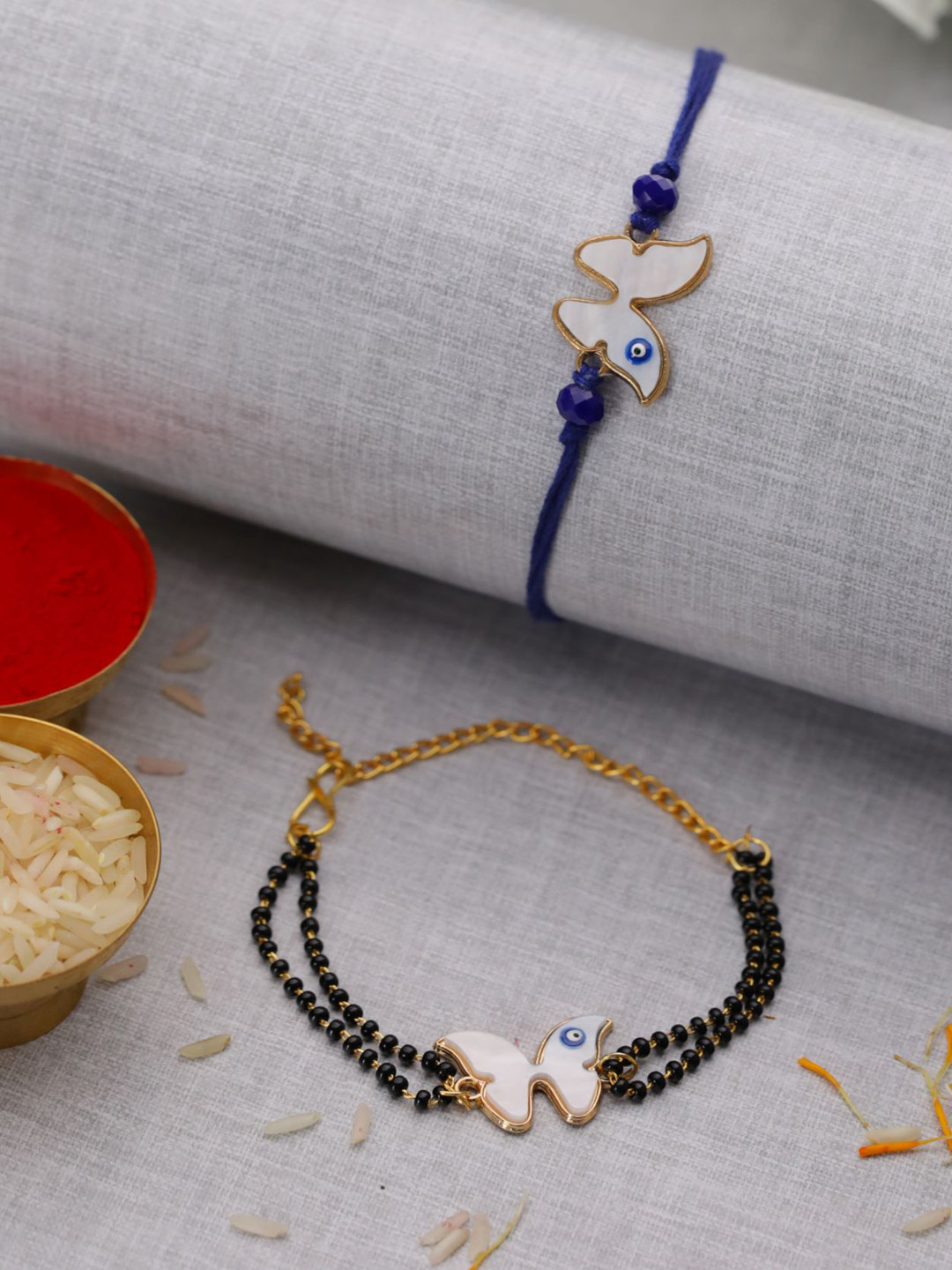 

Jazz and Sizzle Set Of 2 Butterfly Evil Eye Shaped Thread Rakhis With Roli & Chawal, White