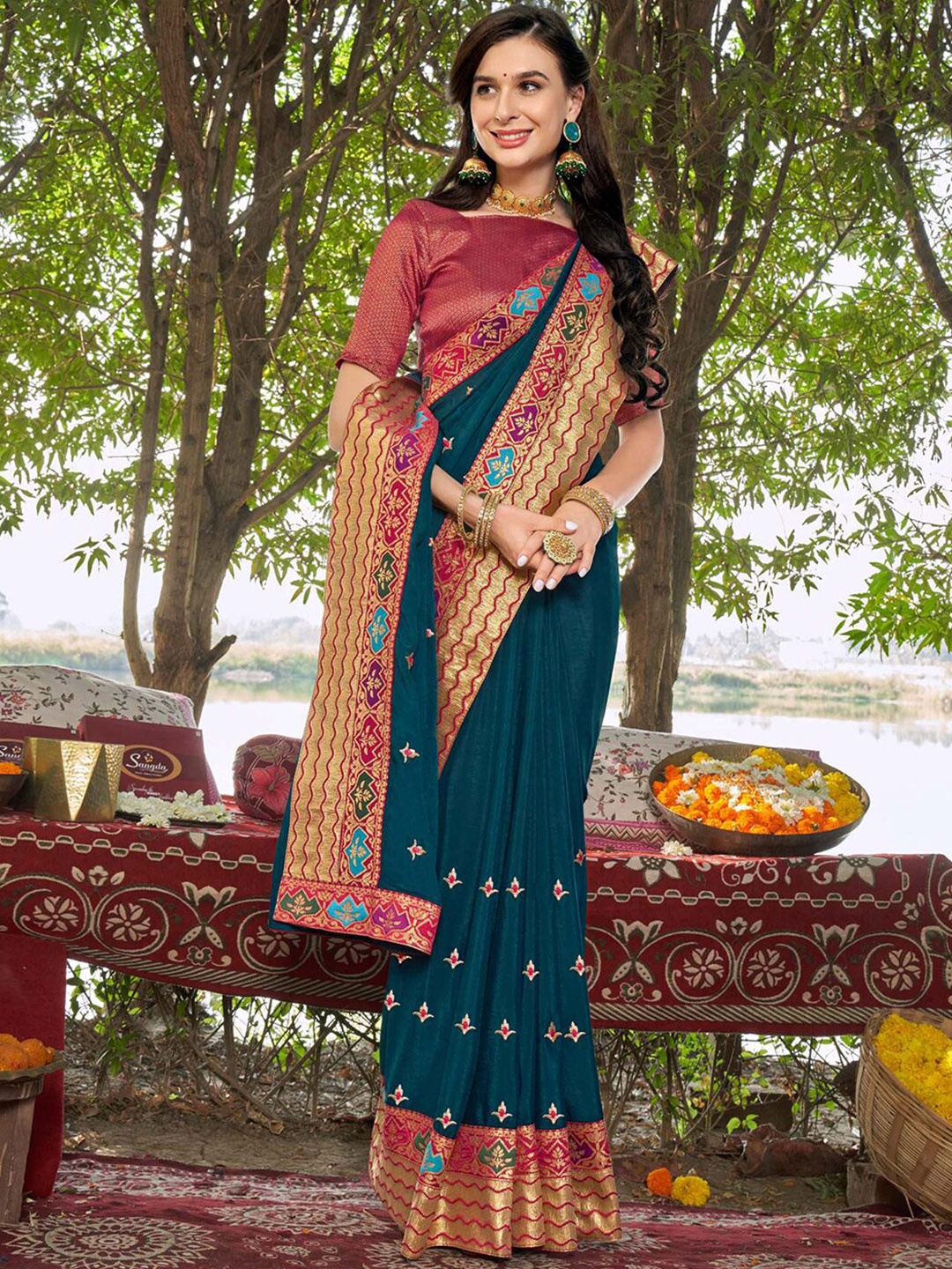 

Mitera Teal & Red Ethnic Motifs Zari Saree