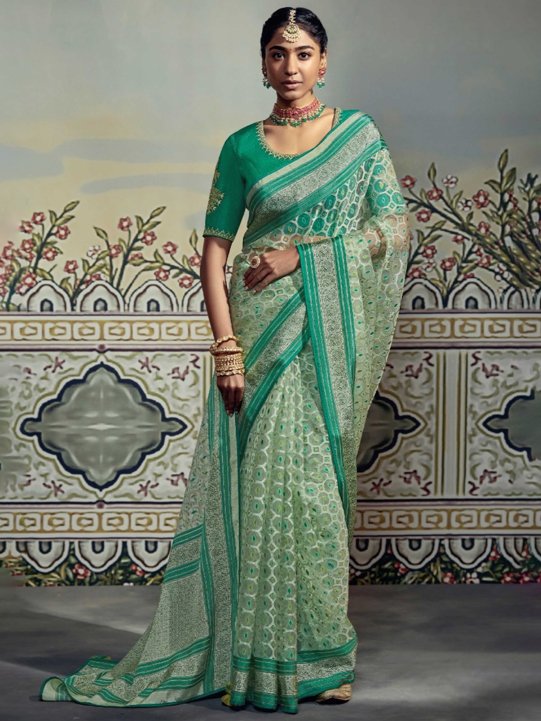 

Mitera Teal & Green EThnic Motif Woven Design Zari Brasso Saree