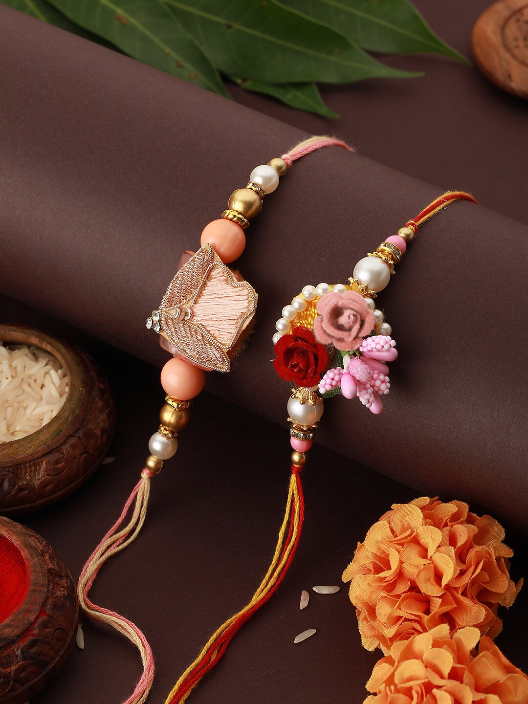 

Saraf RS Jewellery Set Of 2 Kundan & Pearl Beaded Thread Rakhis With Roli Chawal, Peach