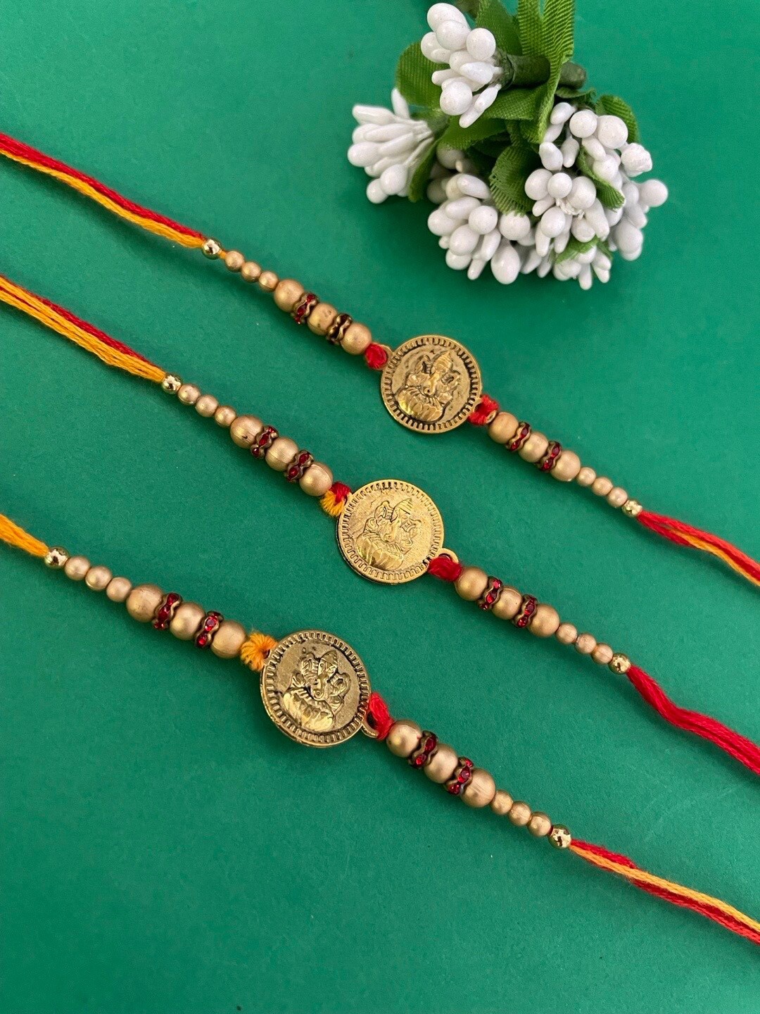 

Digital Dress Room Set Of 3 Ganesh Ji Shell-Studded-Beaded Thread Rakhi, Gold