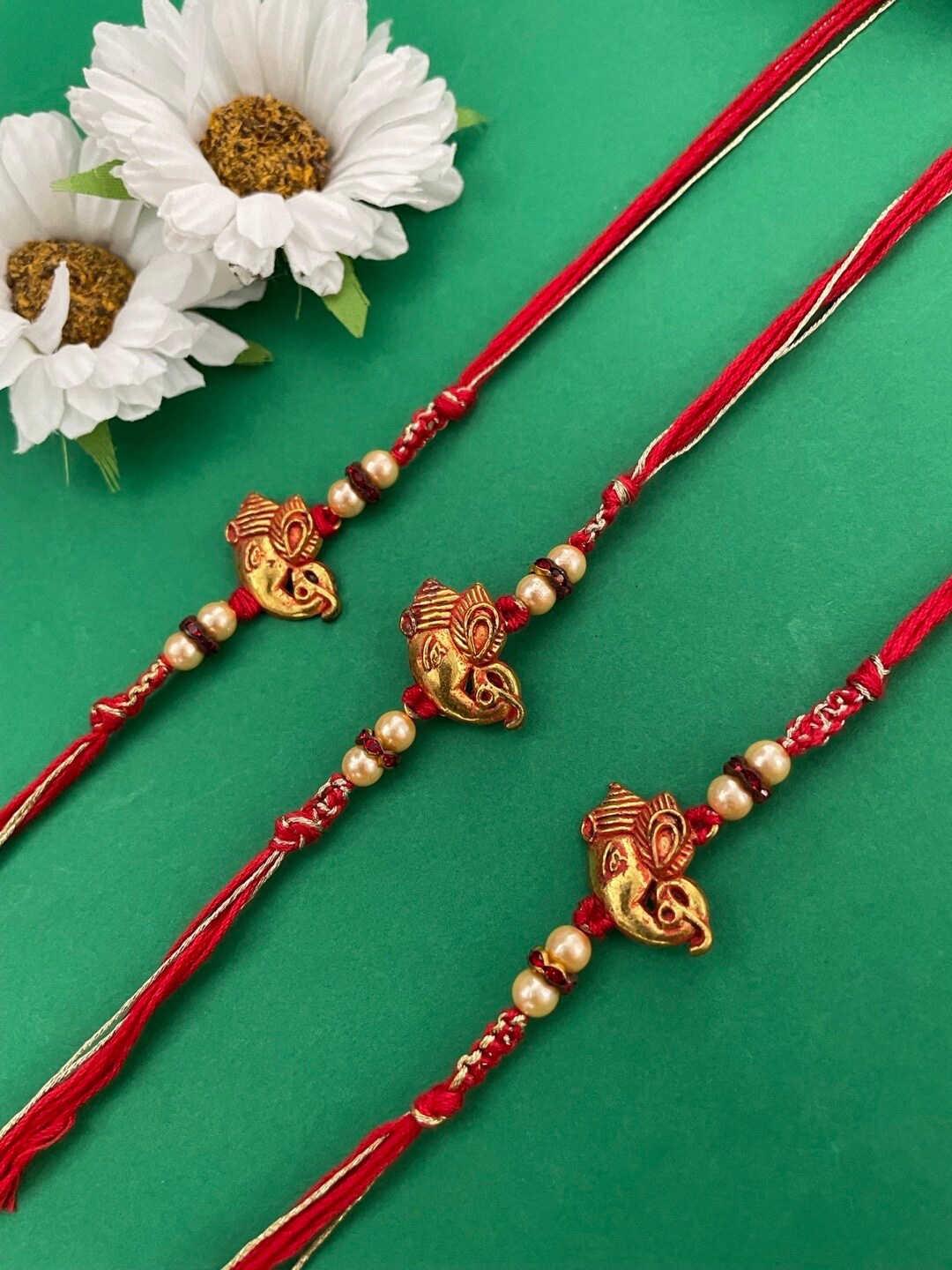 

Digital Dress Room Set Of 3 Gold-Plated Ganesh Charm & Pearls-Beaded Rakhi