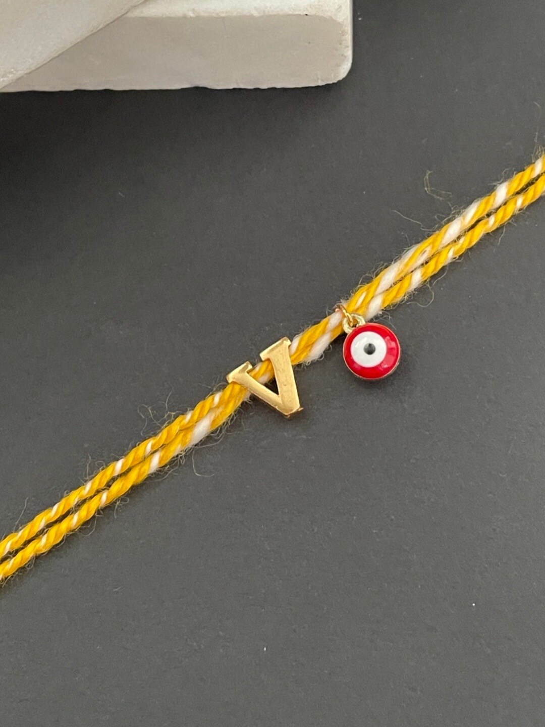 

Digital Dress Room Gold-Plated V Alphabet & Evil Eye Charm Rakhi