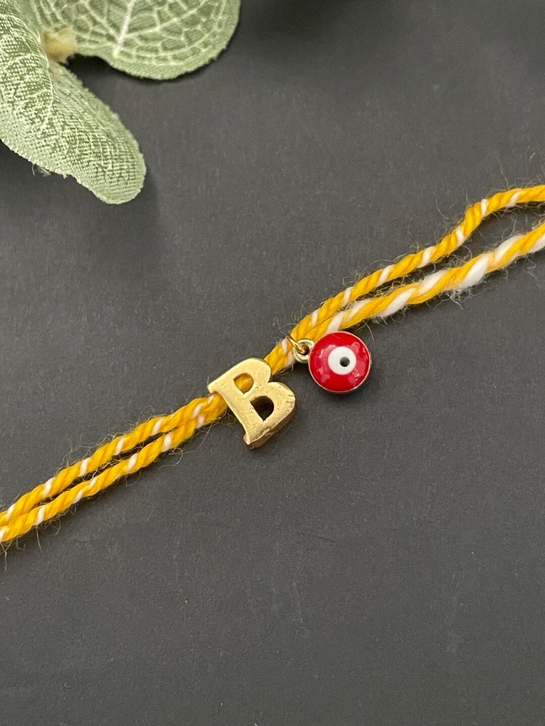 

Digital Dress Room Gold-Plated B Alphabet & Evil Eye Charm Rakhi