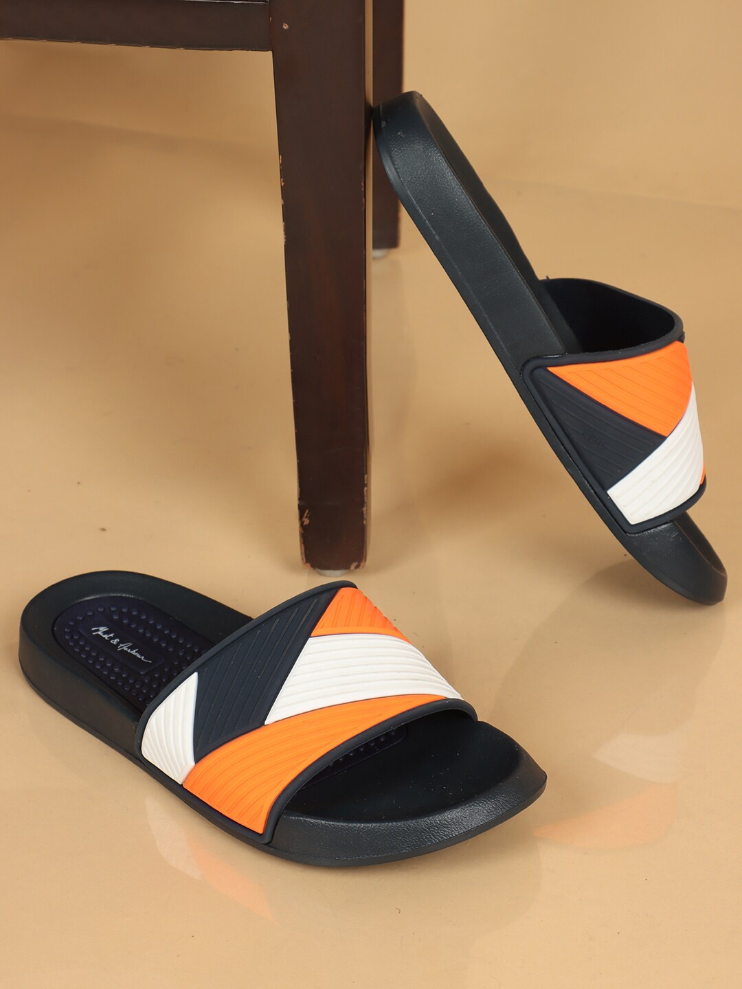 

Mast & Harbour Men Navy Blue & Orange Colourblocked Sliders