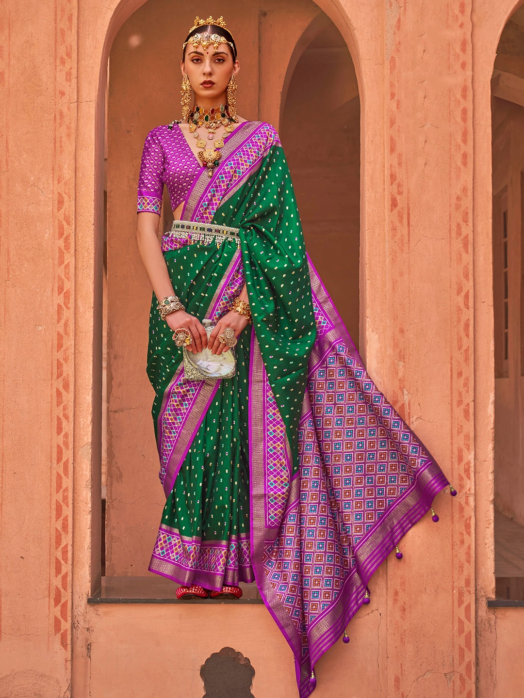 

Mitera Green & Purple Ethnic Motifs Woven Design Zari Patola Saree