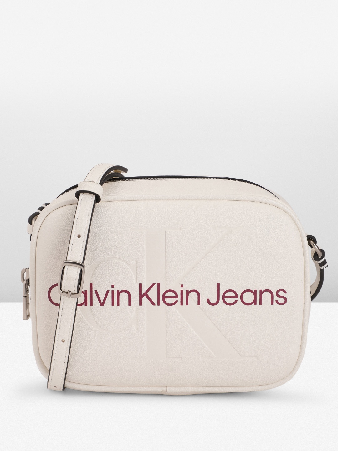 

Calvin Klein Brand Logo Printed & Debossed Structured Sling Bag, White