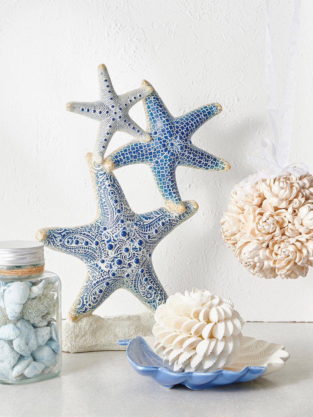 

Home Centre Blue & Off White Embossed Ceramic Decorative Show Piece