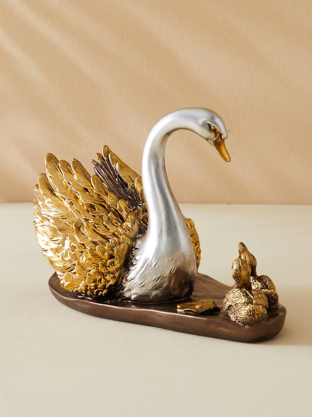 

Home Centre Gold-Toned & Silver Toned Corsica Swam Figurine Showpiece