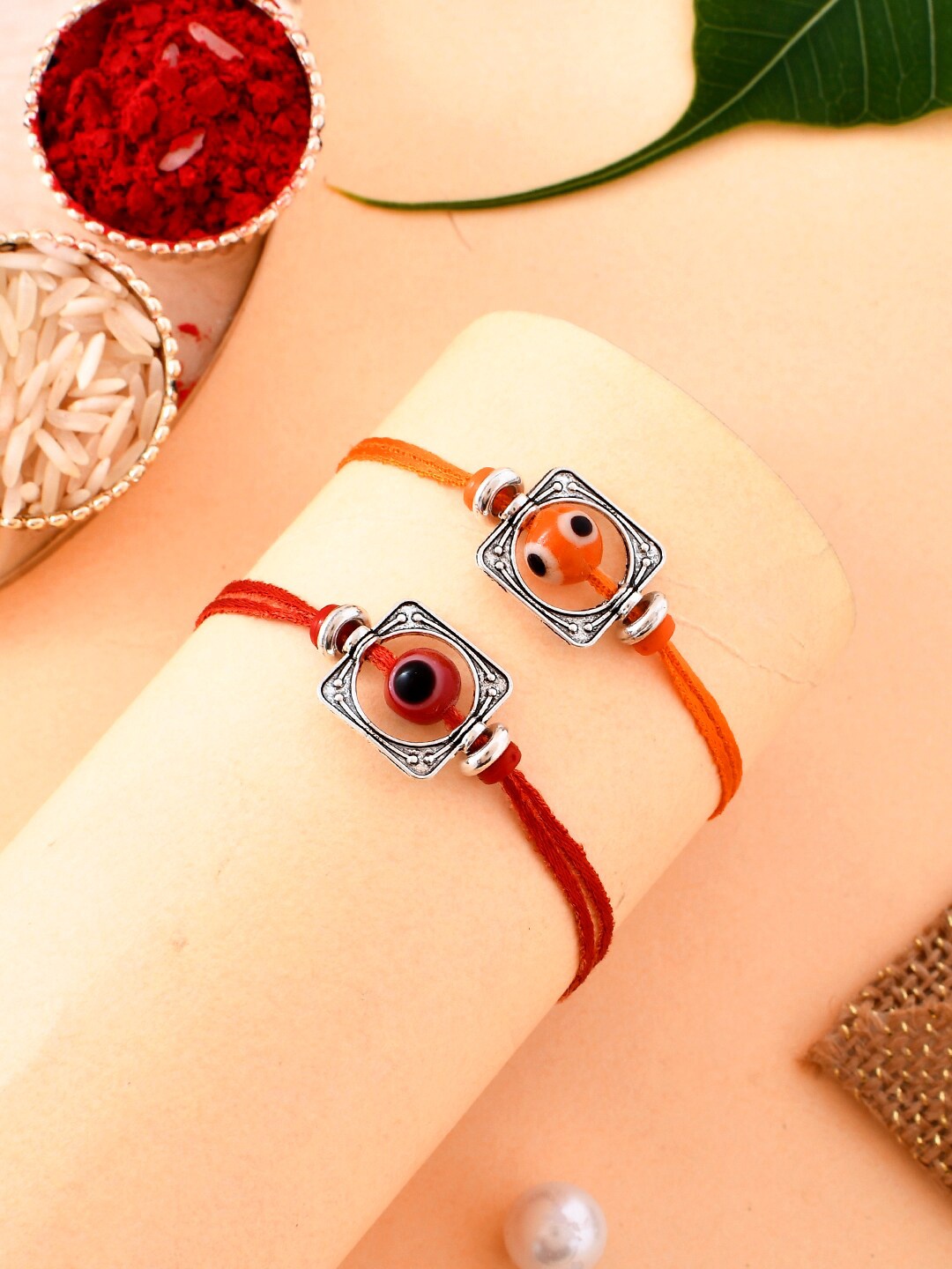 

Aapno Rajasthan Set Of 2 Woven Bead Prestigious Silver Rakhi Set, Red