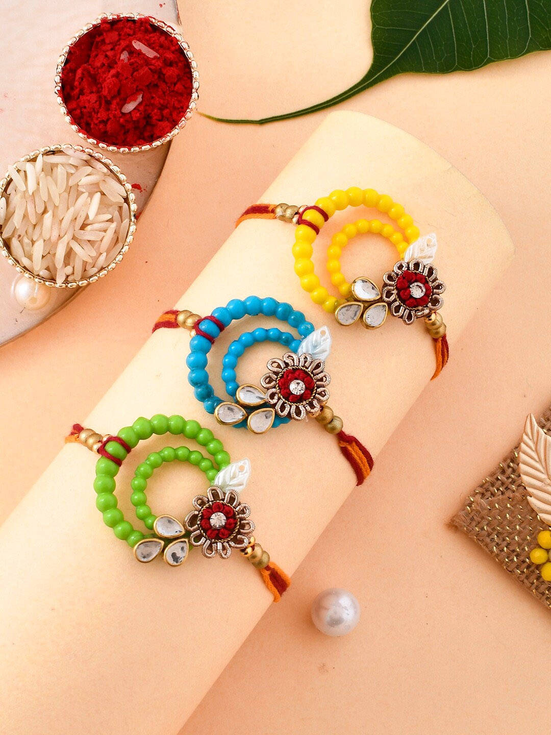 

Aapno Rajasthan Set Of 3 Circular Beaded Rakhi With Roli Rice & Greeting Card, Red