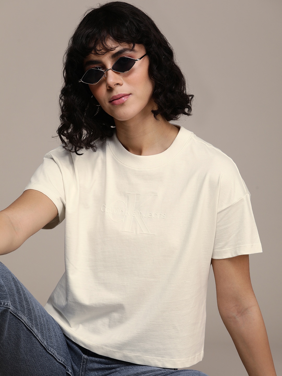 

Calvin Klein Jeans Brand Logo Embossed Drop-Shoulder Pure Cotton Crop T-shirt, Cream
