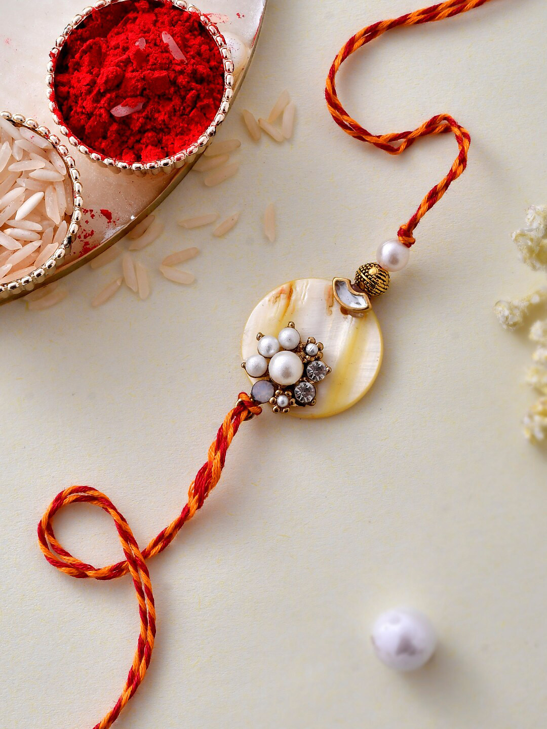 

Aapno Rajasthan Pearl & Beads Enamelled Resin Rakhi, White