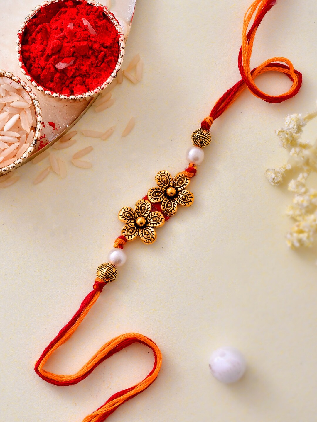 

Aapno Rajasthan Unisex Gold Plated Beautiful Twin Flower Bhaiya Rakhi