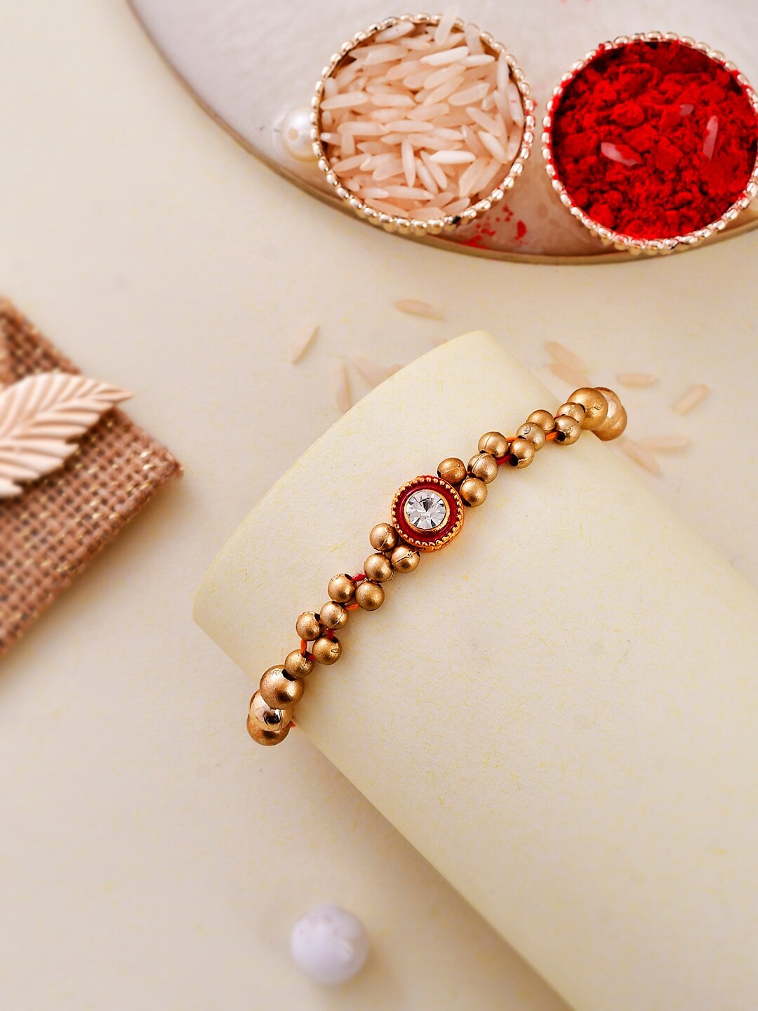 

Aapno Rajasthan Stone-Studded & Beaded Bracelet Rakhi, Gold