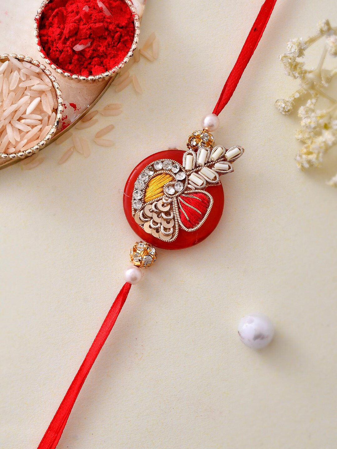 

Aapno Rajasthan Sequin and Kundan Embellished Resin Based Rakhi, Red