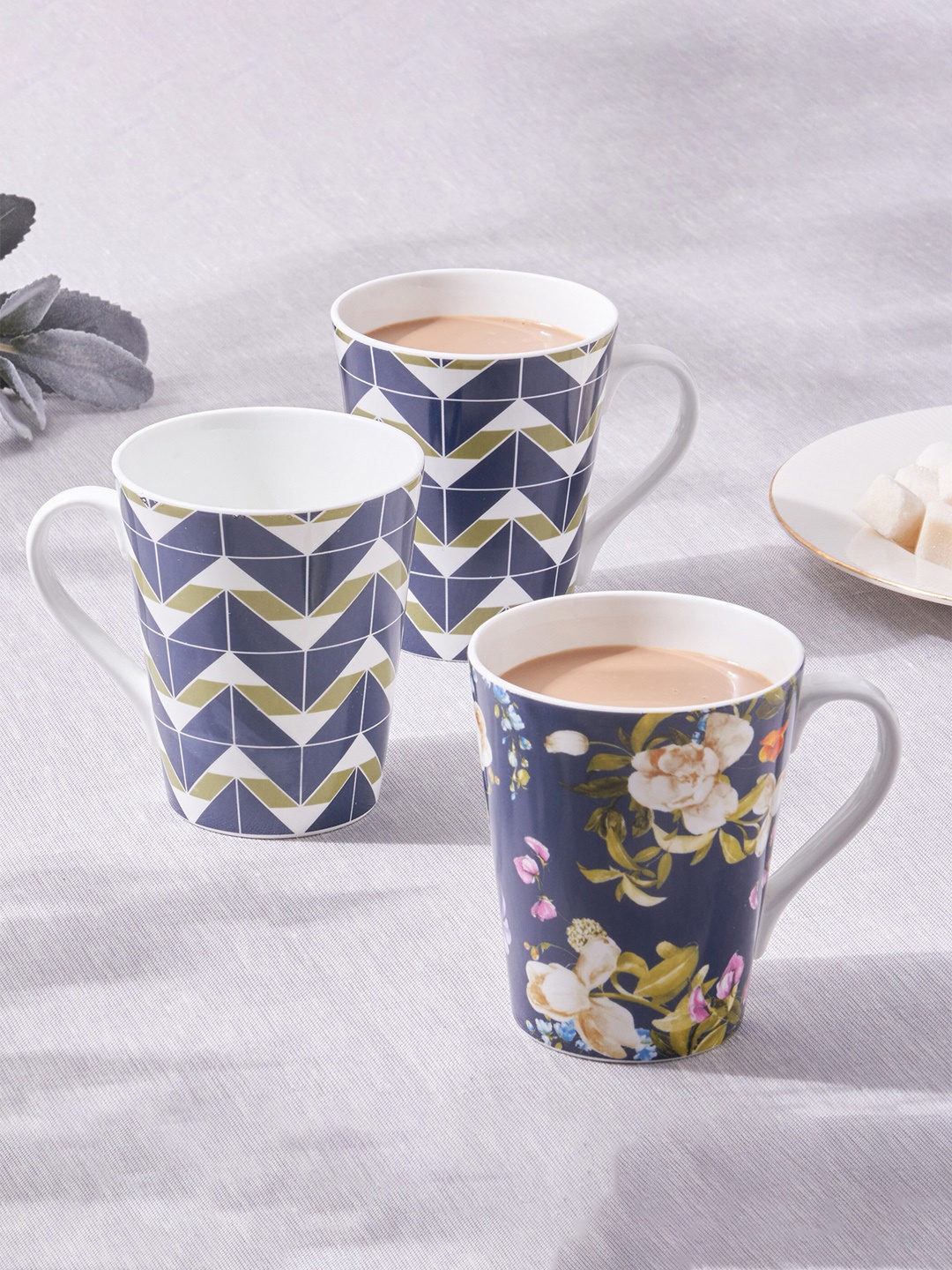 

Home Centre 3 Pcs Blue & Green Printed Bone China Glossy Mugs - 340 ML Each