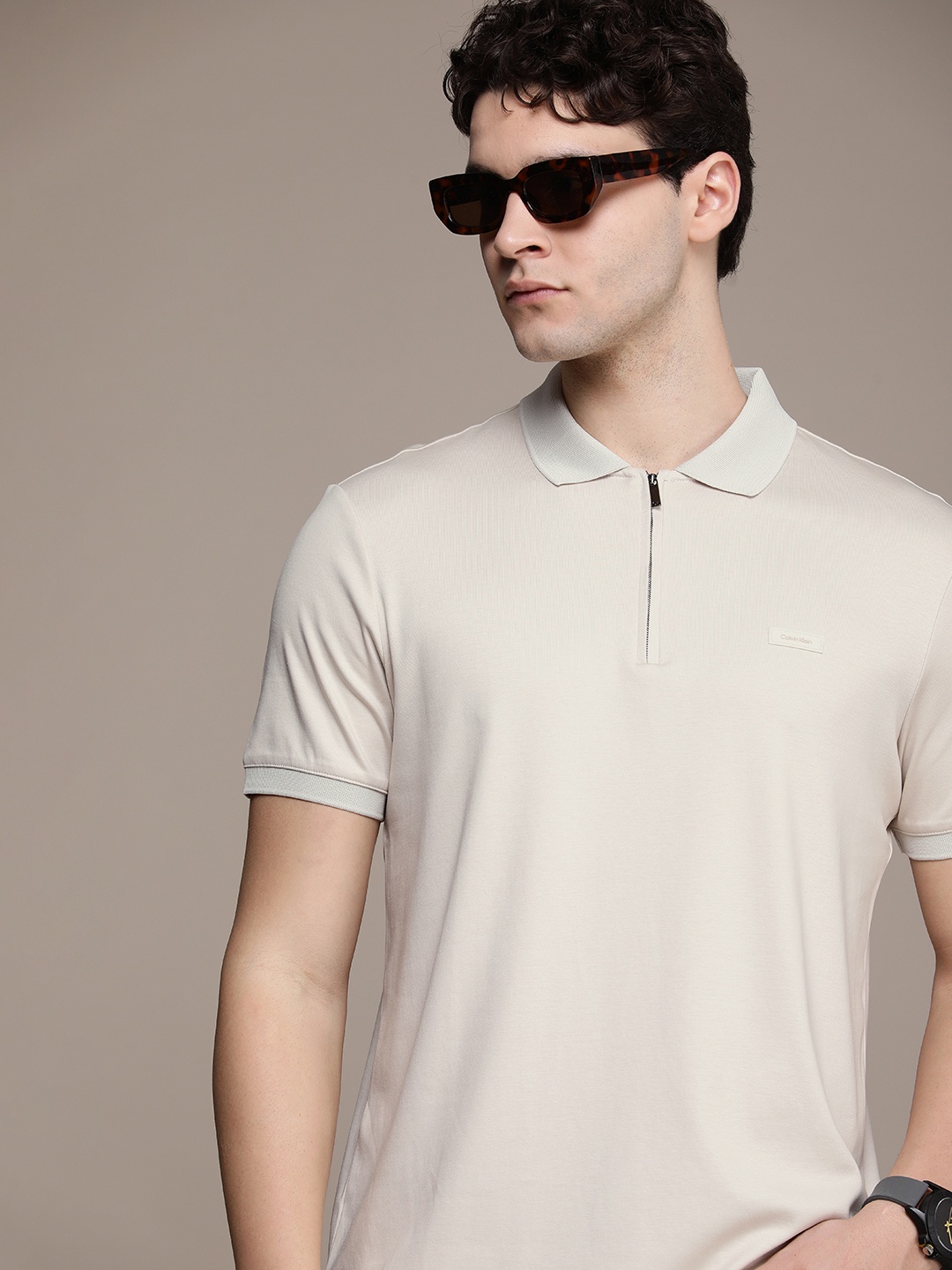 

Calvin Klein Jeans Pure Cotton Polo Collar Solid Casual T-shirt, Beige