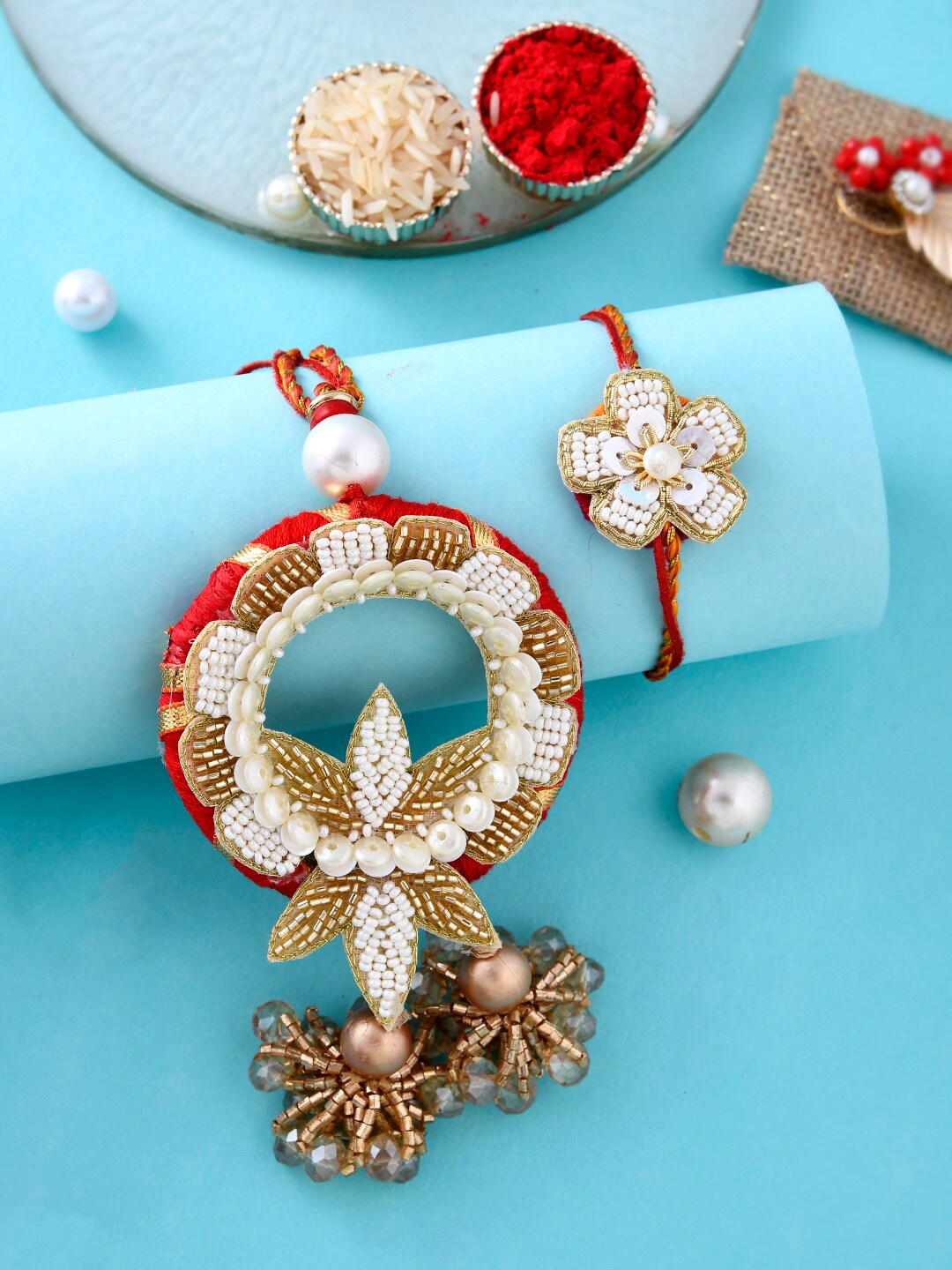 

Aapno Rajasthan Unisex Set Of 2 Pearl Beaded With Roli, Rice & Greeting Card, Gold