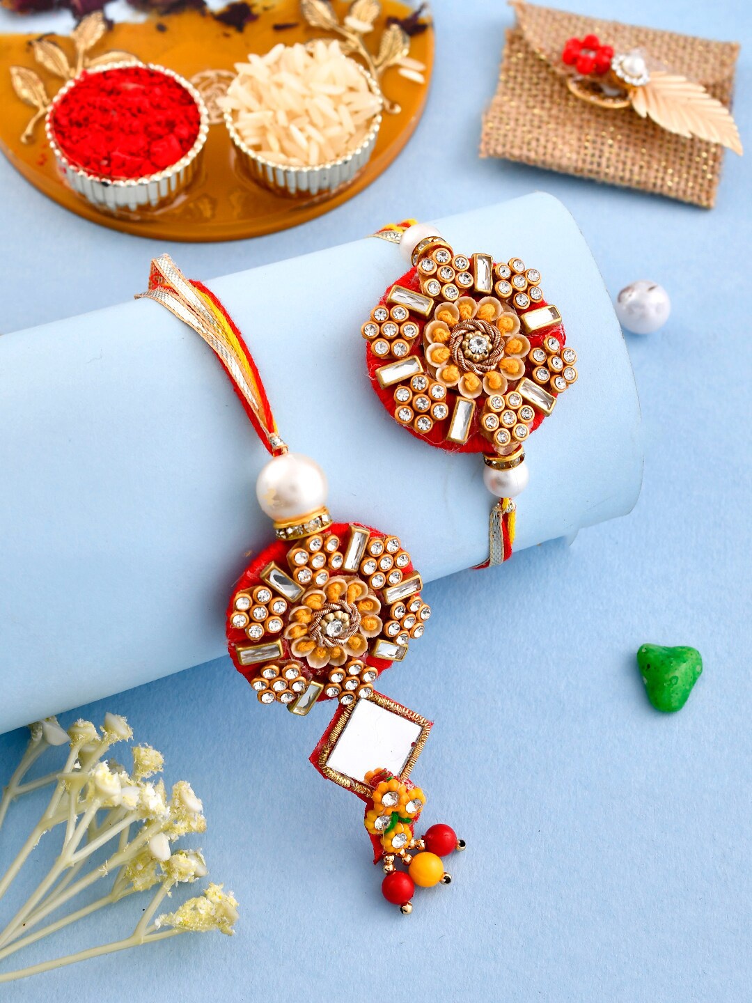 

Aapno Rajasthan Set Of 2 Stone Studded Bhaiya Bhabhi Rakhi With Roli & Chawal, Red