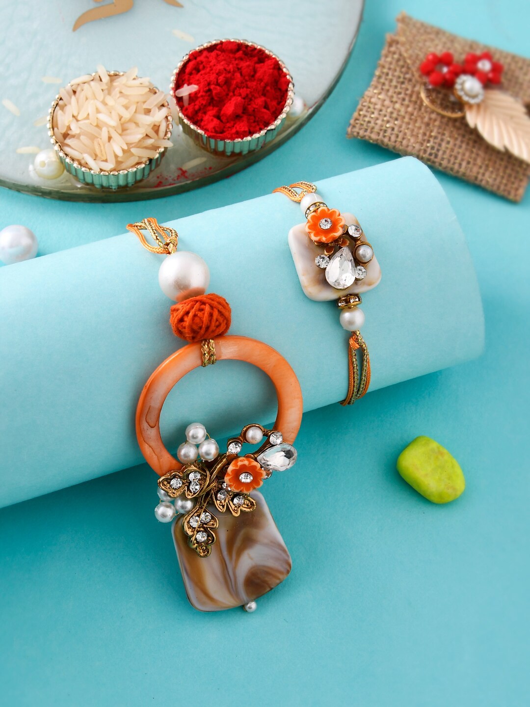 

Aapno Rajasthan Set Of 2 Resin Bhaiya Bhabhi Rakhi With Roli & Chawal, Orange