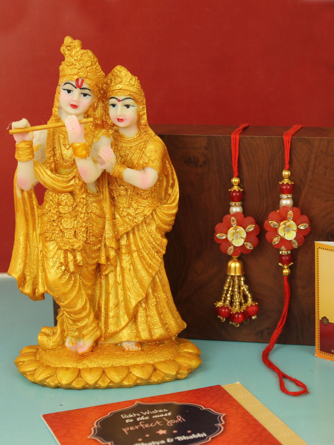

TIED RIBBONS Bhaiya Bhabhi Lumba Rakhi Set with Radha Krishna Statue Gift Set, Red