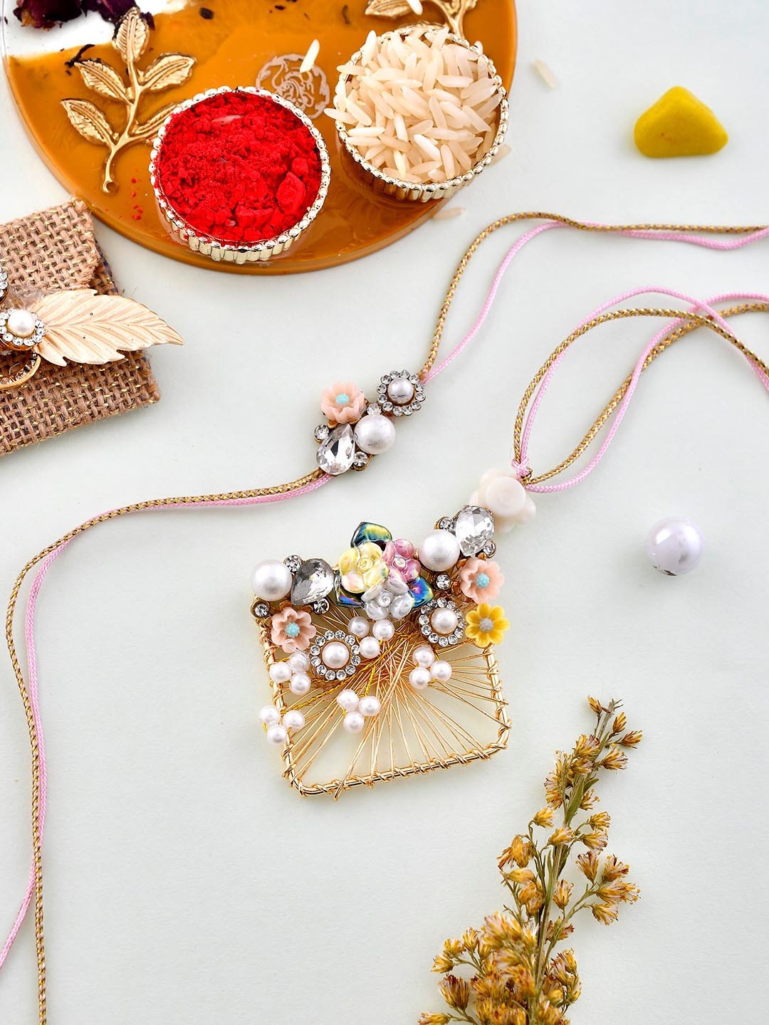 

Aapno Rajasthan Set Of 2 Pearl Embellished Bhaiya Bhabhi Rakhi Set With Box, Gold