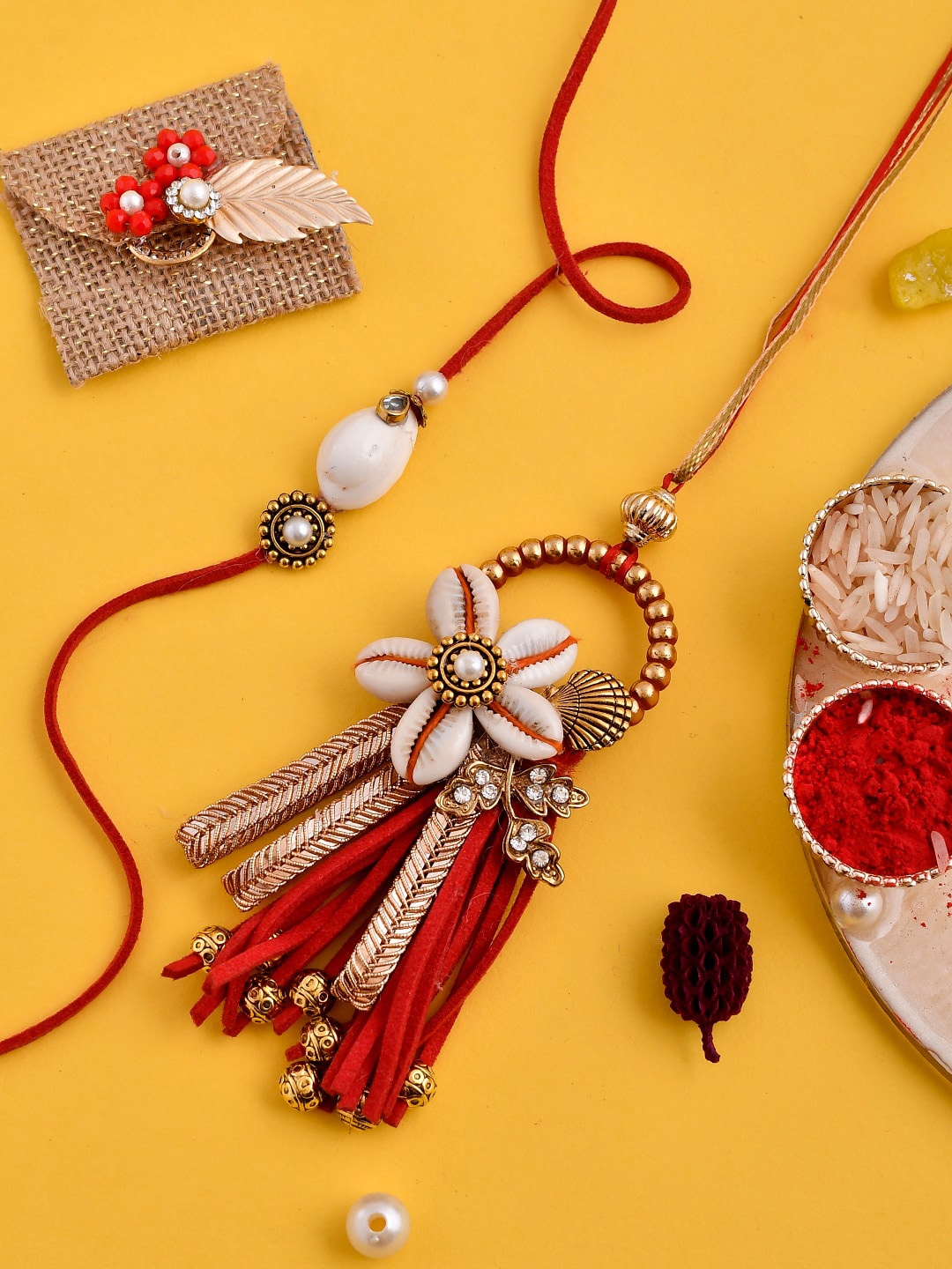 

Aapno Rajasthan Set Of 2 Shell Embellished Bhaiya Bhabhi Rakhi Set With Box, Red